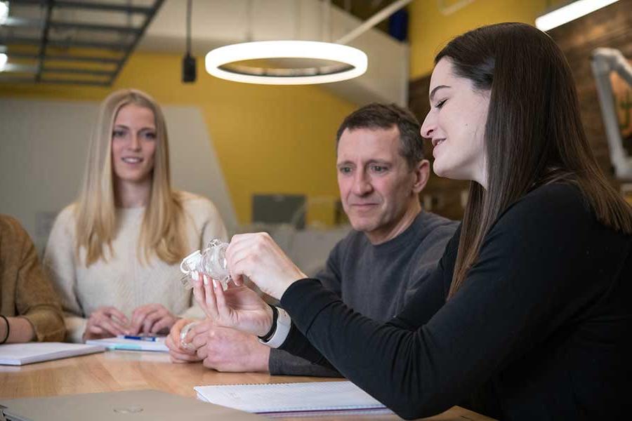 Students working with a professor on a project